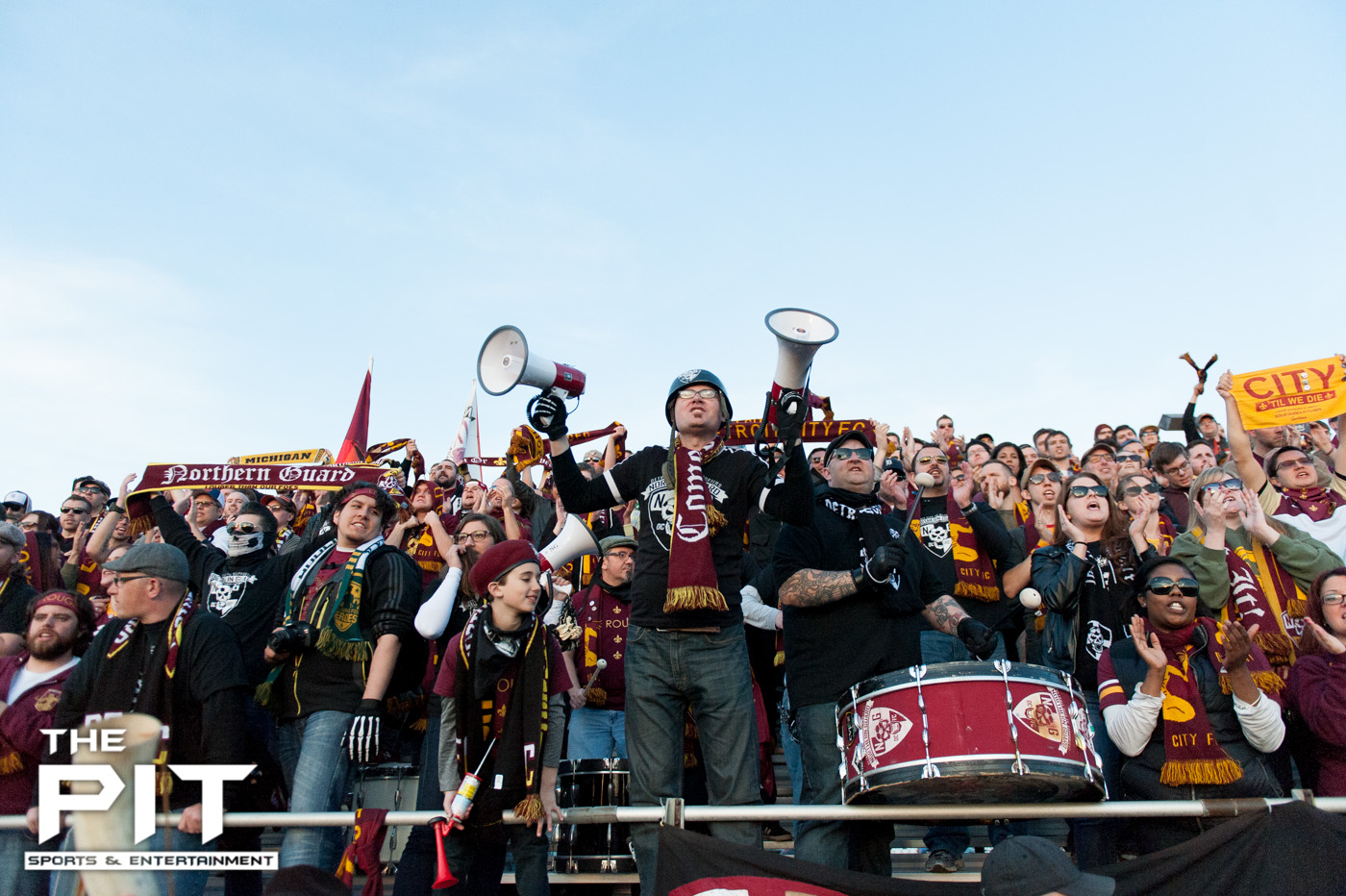 A packed Detroit City FC crowd show off their "Detroit City FC" scarfs to the opposing teams stands at a scrimmage match against Saginaw Valley on April 19, 2014 at Hurley Field. Brian Quintos / The Pit: SE
