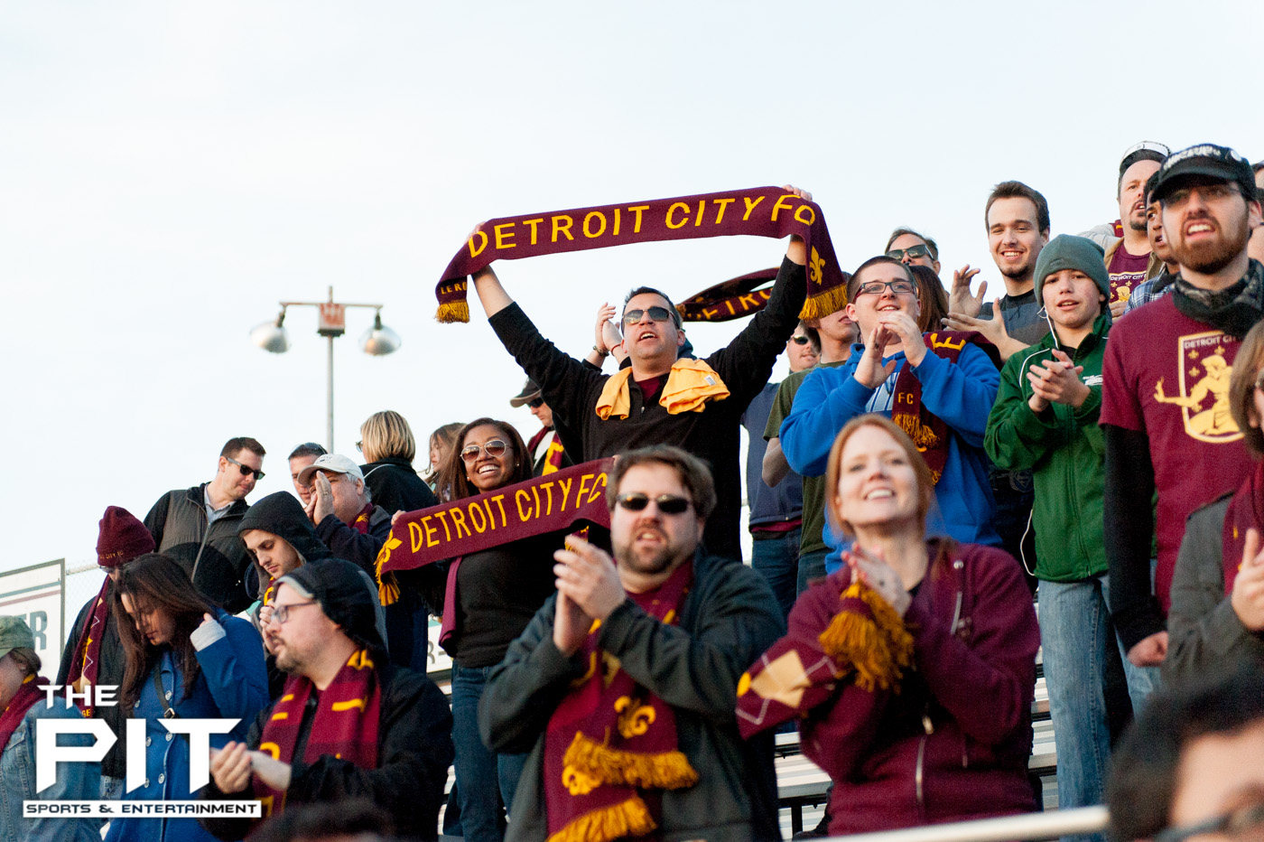 A packed Detroit City FC crowd show off their "Detroit City FC" scarfs to the opposing teams stands at a scrimmage match against Saginaw Valley on April 19, 2014 at Hurley Field. Brian Quintos / The Pit: SE