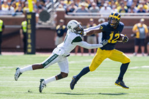 Michigan's Chris Evans (12) carries the ball during the Wolverines' 63-3 rout of Hawaii last weekend. Evans and other Michigan freshmen will look to make an even bigger impact against UCF Saturday. Photo/MGoBlue.com
