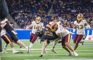 Northwestern wideout Griffin Wilde is tackled by Central Michigan defenders after making a catch in the first half of the GameAbove Sports Bowl at Ford Field in Detroit on Friday, Dec. 26, 2025. (Tony Patroske/TPM)