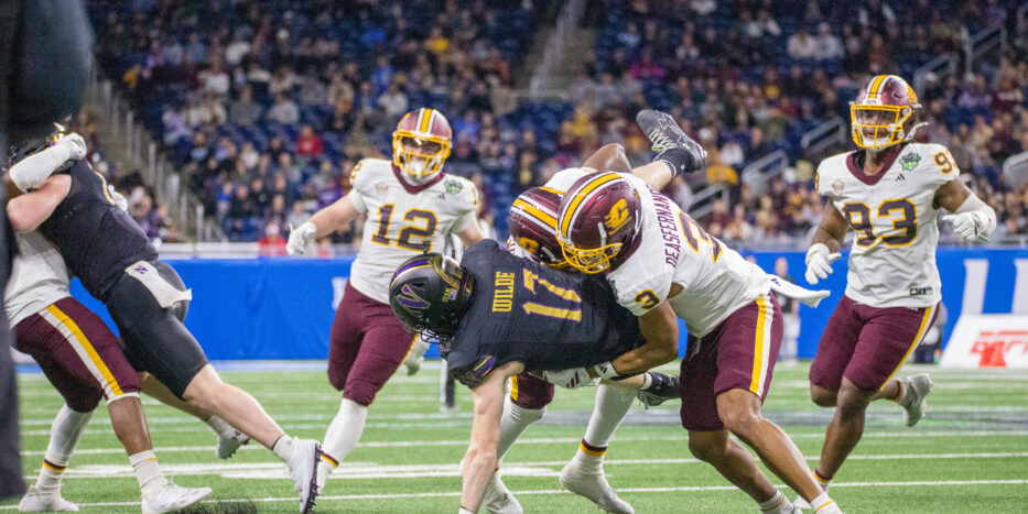 Northwestern wideout Griffin Wilde is tackled by Central Michigan defenders after making a catch in the first half of the GameAbove Sports Bowl at Ford Field in Detroit on Friday, Dec. 26, 2025. (Tony Patroske/TPM)