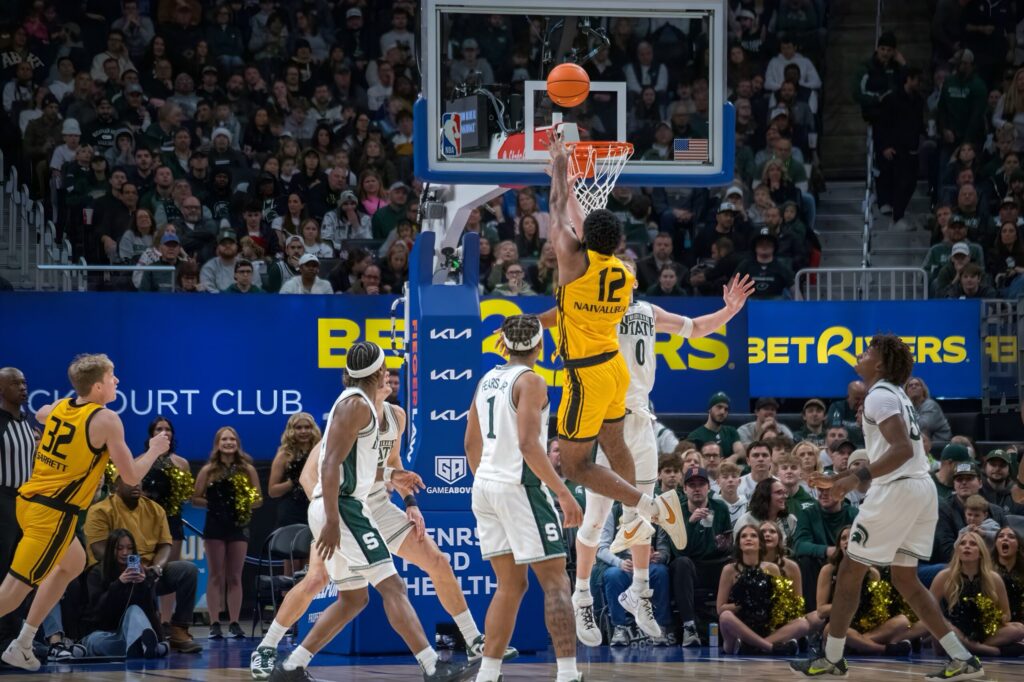Oakland forward Tuburu Naivalurua shoots over Spartan defenders during a game on Saturday, December 20, 2025, at Little Caesars Arena in Detroit. Michigan State won, 79-70. (Tony Patroske/TPM)