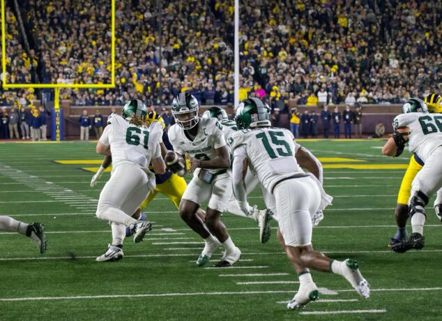 Michigan State quarterback Aidan Chiles hands the ball off during a game against Michigan in Ann Arbor in 2025. (Tony Patroske/TPM)