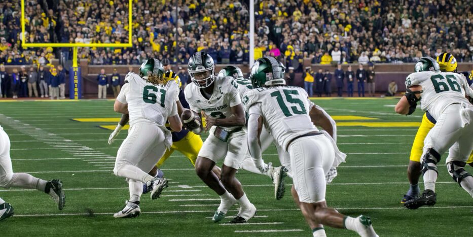 Michigan State quarterback Aidan Chiles hands the ball off during a game against Michigan in Ann Arbor in 2025. (Tony Patroske/TPM)