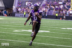 Northwestern quarterback Aidan Chiles scrambles against Ball State on Saturday at New Ryan Field. (Damien Dennis/TPM)